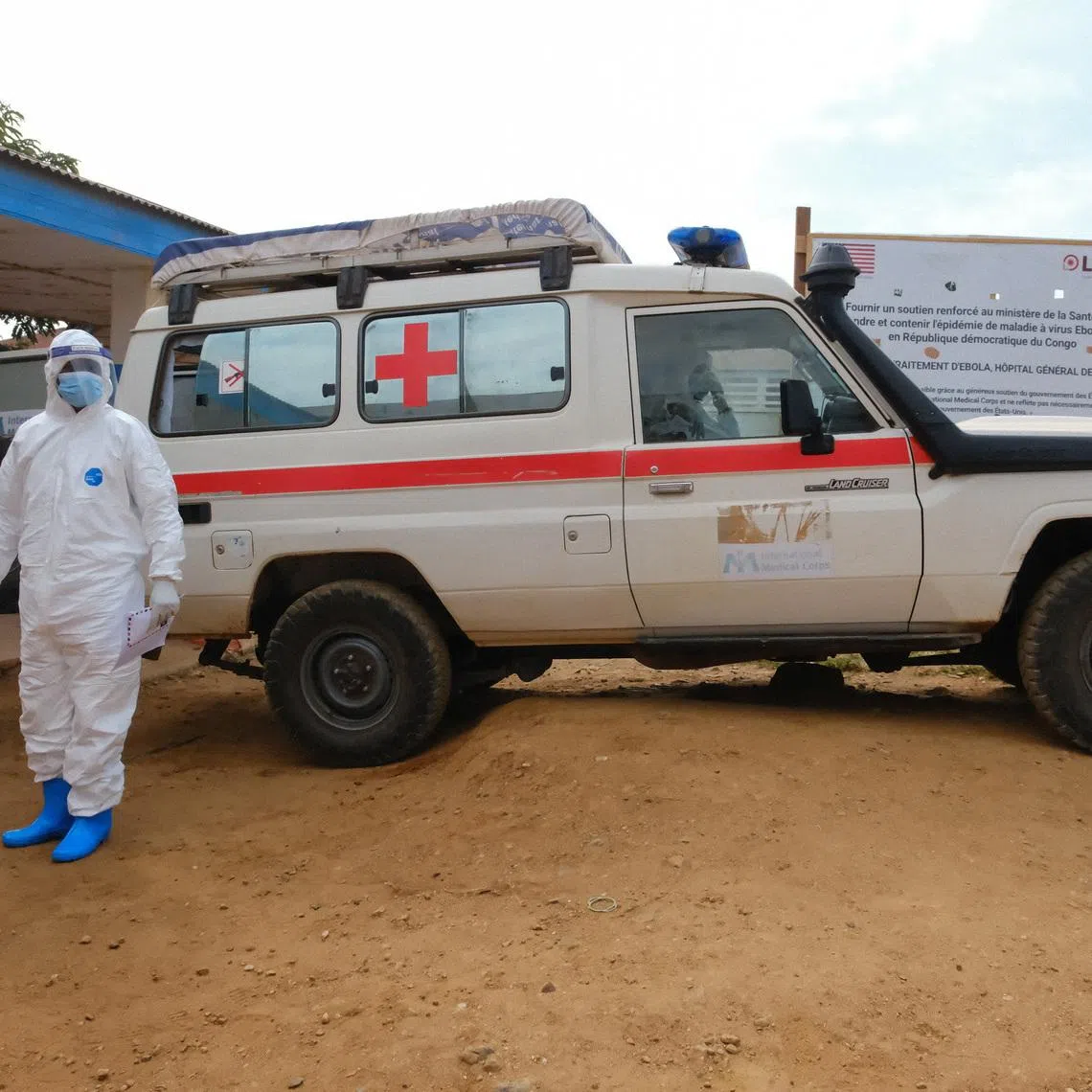 A doctor wearing personal protective equipment (PPE) stands near an ambulance at the Ebola Virus Disease Treatment Center at the Bunia General Reference Hospital, one month after cases were confirmed in Bunia, eastern Democratic Republic of Congo, June 15, 2026. REUTERS/Gradel Muyisa Mumbere