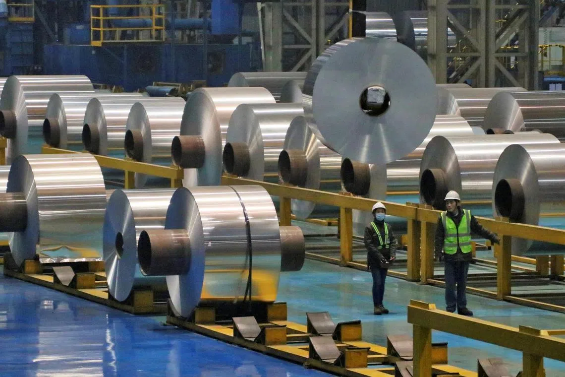 Employees work at the production line of aluminium rolls at a factory in Zouping, Shandong province, China November 23, 2019. Picture taken November 23, 2019. REUTERS/Stringer ATTENTION EDITORS - THIS IMAGE WAS PROVIDED BY A THIRD PARTY. CHINA OUT./File Photo