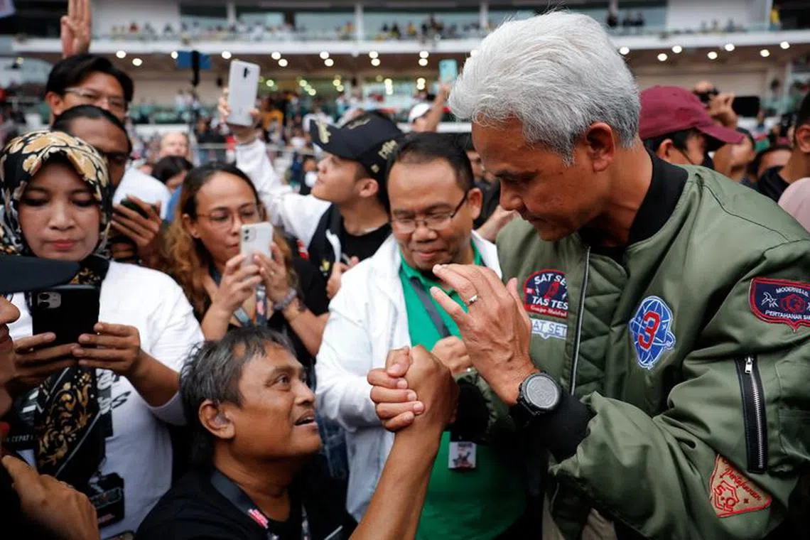 FILE PHOTO: Presidential candidate of the ruling Indonesian Democratic Party of Struggle (PDI-P) Ganjar Pranowo greets his supporter during his campaign rally at the Gelora Bung Karno stadium in Jakarta, Indonesia, February 3, 2024. REUTERS/Willy Kurniawan