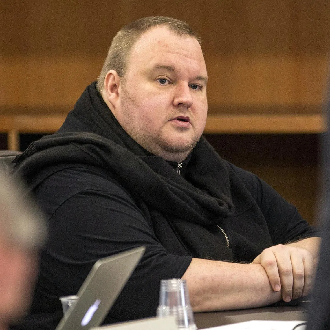 Kim Dotcom sitting in a chair during a court hearing in Auckland, New Zealand, on Sept 24, 2015.