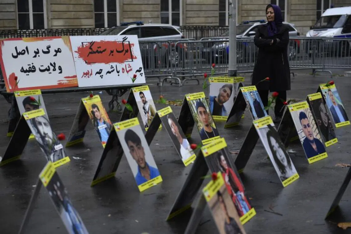 Placards with portraits of people killed in Iran's protests in Paris on Dec 6, 2022. 