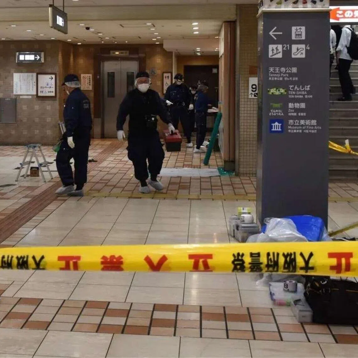 Investigators examine the scene where a woman was stabbed in Osaka City on June 10.