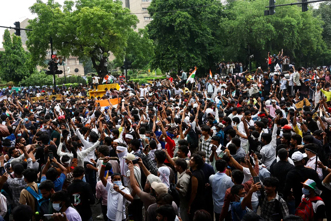 Supporters of India’s Cockroach Janta Party celebrate in New Delhi on July 25 after India’s Education Minister Dharmendra Pradhan resigned over examination paper leaks.