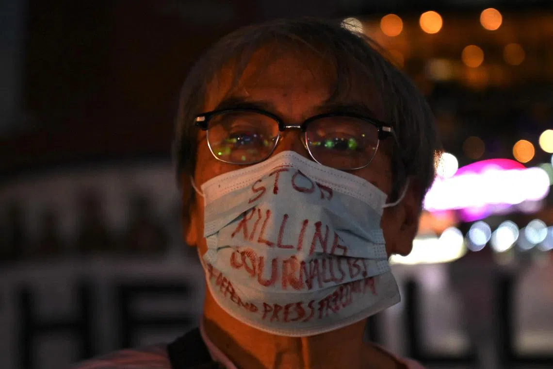 A man wears a facemask that says “Stop Killing Journalists” at a rally calling for justice following the murder of a Philippine radio broadcaster, in Quezon City in suburban Manila on October 4, 2022. - A Philippine radio broadcaster and government critic was shot dead near his home in suburban Manila, police said October 4, the latest in a long list of journalists killed in the country. (Photo by JAM STA ROSA / AFP)