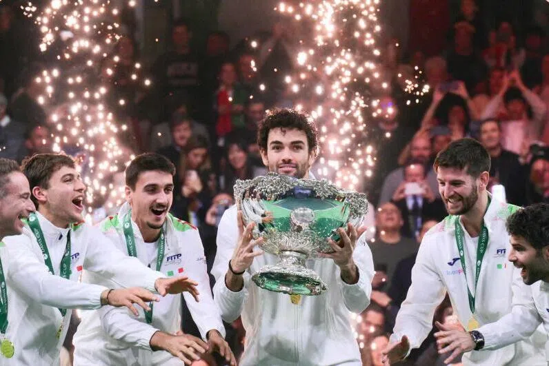 Italy's Matteo Berrettini (centre) surrounded by teammates as he lifts the David Cup trophy after their victory over Spain in Bologna, Italy.