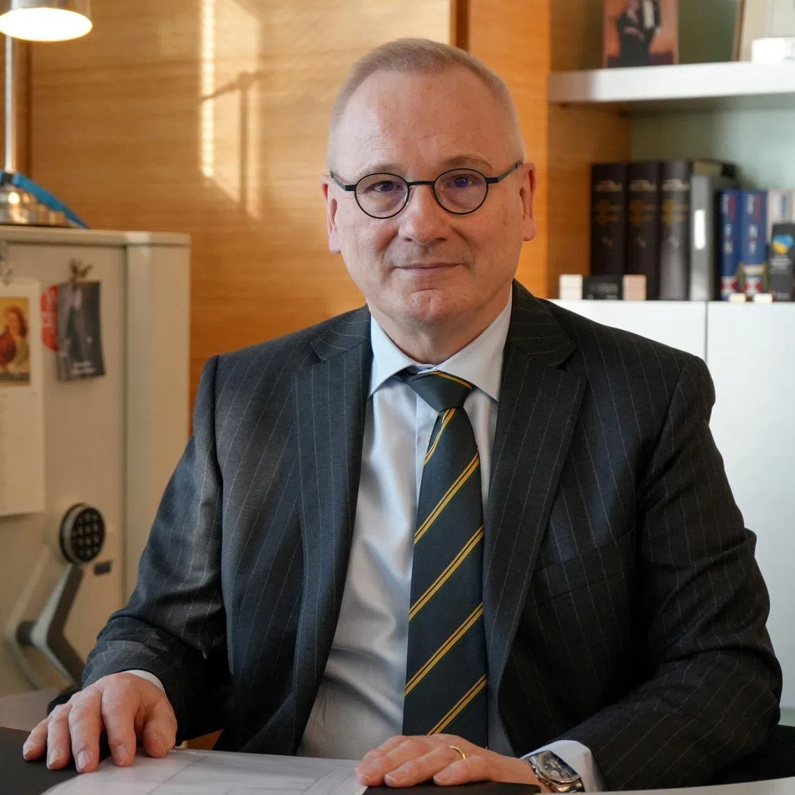 Robert in den Bosch, the Disarmament Ambassador and Permanent Representative to the Conference on Disarmament of the Kingdom of the Netherlands in Geneva, and Chair of the Convention on Certain Conventional Weapons Group of Governmental Experts on Emerging Technologies in Lethal Autonomous Weapons Systems, sits at a desk in his office in Geneva, Switzerland February 25, 2026. REUTERS/Olivia Le Poidevin