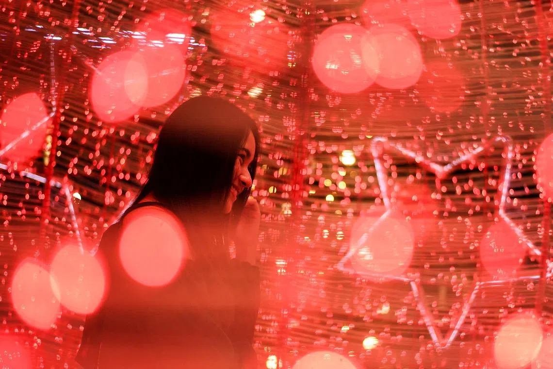 A woman visits illuminated decorations assembled ahead of Christmas and New Year's celebrations, at a department store in Bangkok, Thailand, December 22, 2022. 