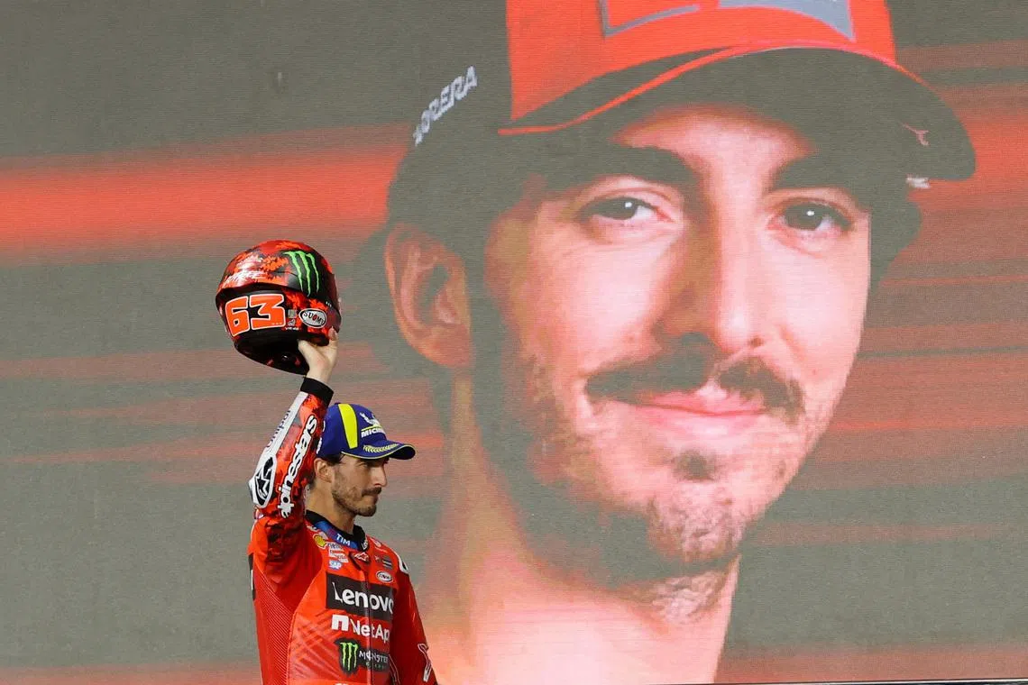 MotoGP - Qatar Grand Prix - Lusail International Circuit, Doha, Qatar - April 13, 2025 Ducati Lenovo Team's Francesco Bagnaia celebrates on the podium after finishing third in the Qatar Grand Prix REUTERS/Ibraheem Al Omari