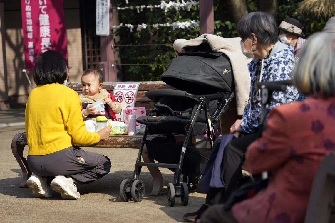 epa10519773 A mother feeds her baby as elderly people look on, in Tokyo, Japan, 09 March 2023 (issued 13 March 2023). According to figures released by the Ministry of Health on 28 February 2023, births in 2022 reached a new record low in Japan, marking the country's first ever dip below 800.000 and accelerating its overall demographic decline. The government plans to respond to this challenge with financial aid for families, yet many experts consider this approach insufficient. EPA-EFE/FRANCK ROBICHON