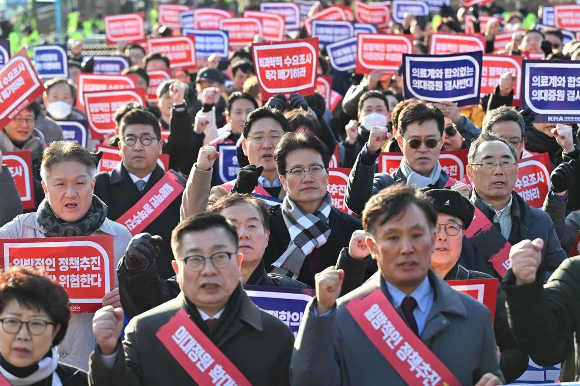 Doctors attending a rally on Feb 25 to protest against the government’s plan to raise the annual enrolment quota at medical schools, near the Presidential Office in Seoul on February 25, 2024. South Korea has raised its public health alert to the highest level, authorities announced on February 23, saying health services were in crisis after thousands of doctors resigned over proposed medical reforms. (Photo by Jung Yeon-je / AFP)