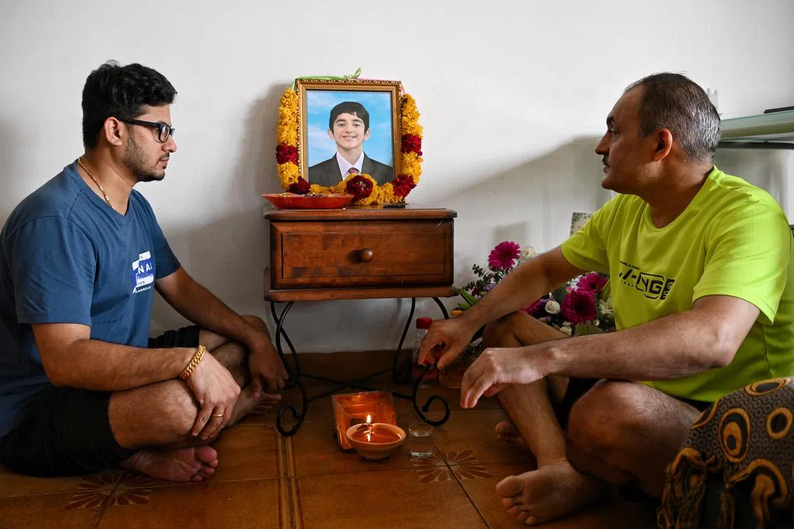 ST20231013_202307798474 Kua Chee Siong/ dgbad13/ Mr Prem Singh Madhaik (right), father of 14-year-old Singapore sports school student, Pranav Madhaik who died on Wednesday, with a family friend, Mr Raj Menon (left) at his home on Oct 13, 2023.