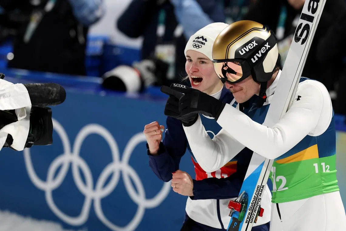 Milano Cortina 2026 Olympics - Ski Jumping - Mixed Team - Predazzo Ski Jumping Stadium, Predazzo, Italy - February 10, 2026. Nika Vodan and Anze Lanisek of Slovenia react after the final round. REUTERS/Kacper Pempel