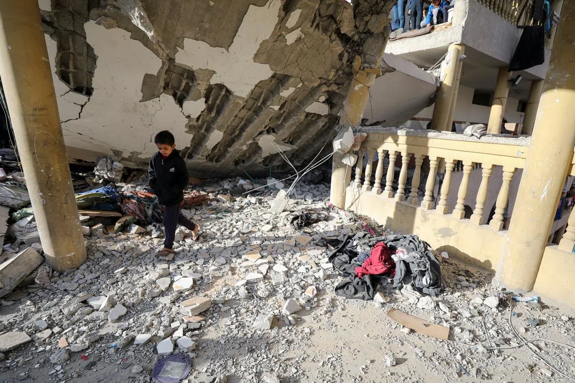 A Palestinian boy walks at the site of an Israeli strike on a school sheltering displaced people, amid the Israel-Hamas conflict, in Gaza City November 27, 2024. REUTERS/Dawoud Abu Alkas