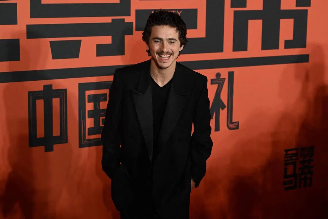 Timothee Chalamet poses upon arrival on the red carpet for screening of his film Marty Supreme in Beijing on March 10.