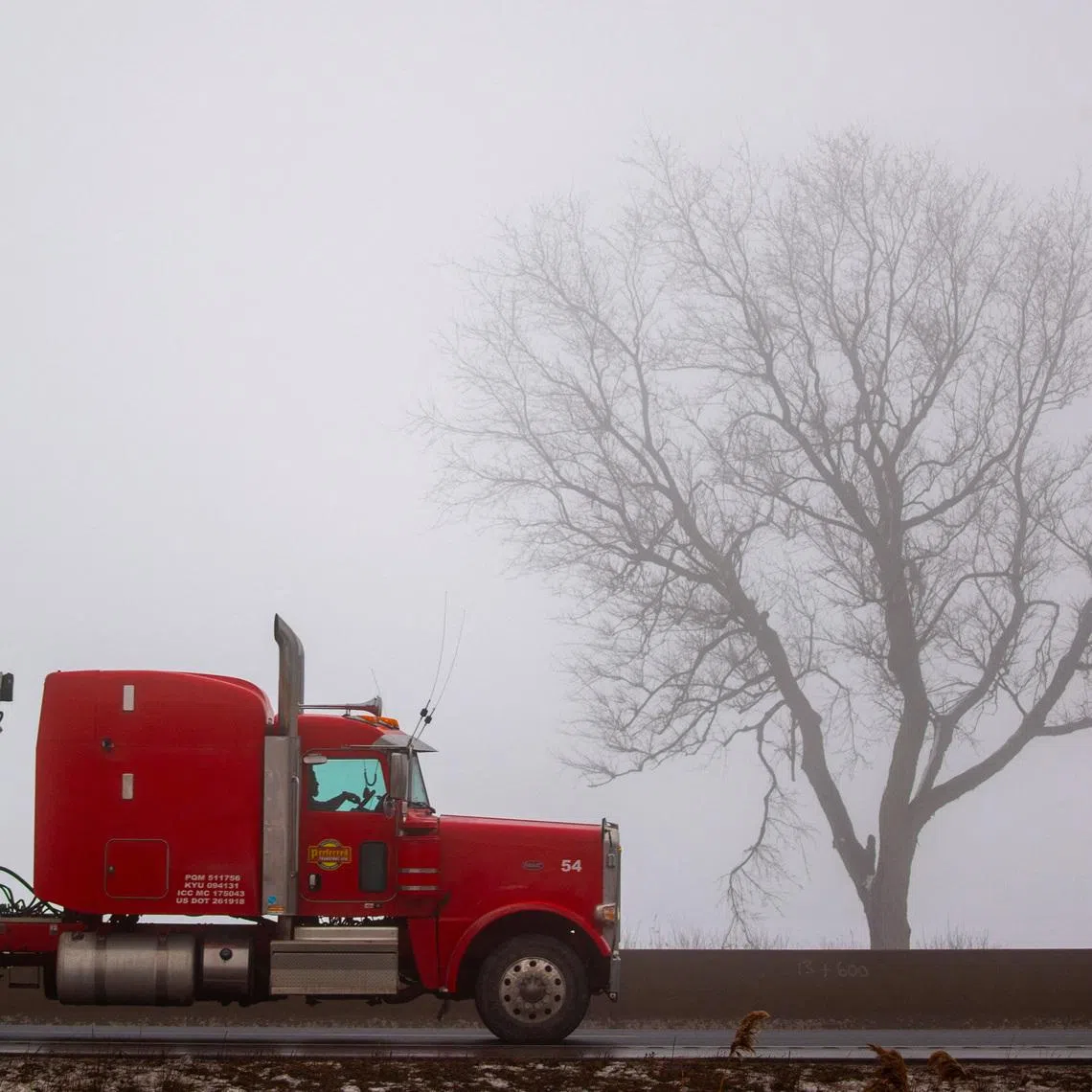 A transport truck travels along Highway 401, a vital trade corridor linking Canada to U.S. markets, Ingersoll, Ontario, Canada, February 3, 2025. REUTERS/Carlos Osorio