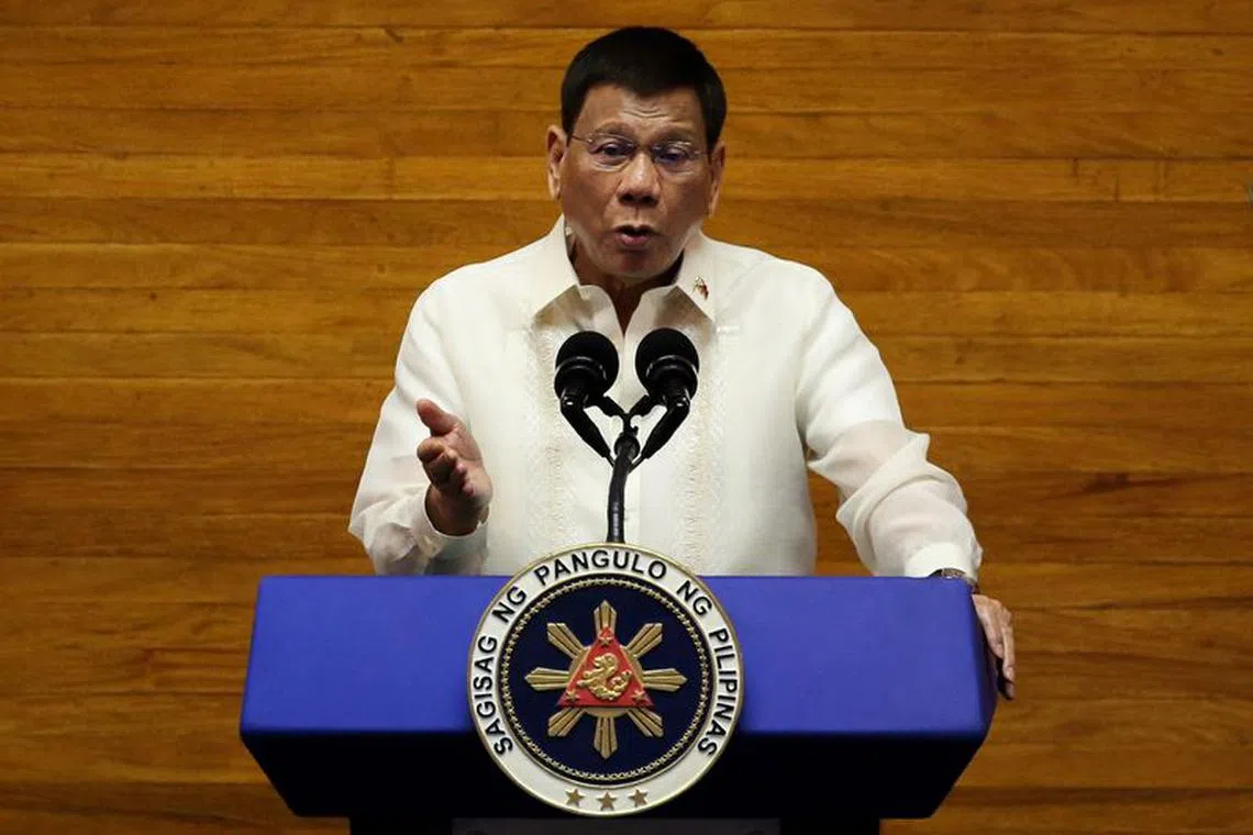 FILE PHOTO: Philippine President Rodrigo Duterte gestures as he delivers his 6th State of the Nation Address (SONA), at the House of Representative in Quezon City, Metro Manila, Philippines, July 26, 2021. REUTERS/Lisa Marie David/File Photo