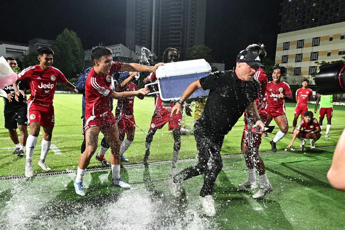 Balestier Khalsa FC players celebrate by pouring a container of ice over their departing coach Peter de Roo after their Singapore Premier League match against Albirex Niigata at Bishan Stadium.

