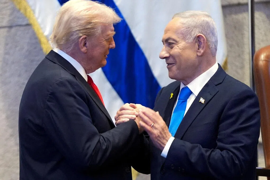 FILE PHOTO: President Donald Trump talks with Israel's Prime Minister Benjamin Netanyahu at the Knesset, Monday, Oct. 13, 2025, in Jerusalem.     Evan Vucci/Pool via REUTERS/File Photo