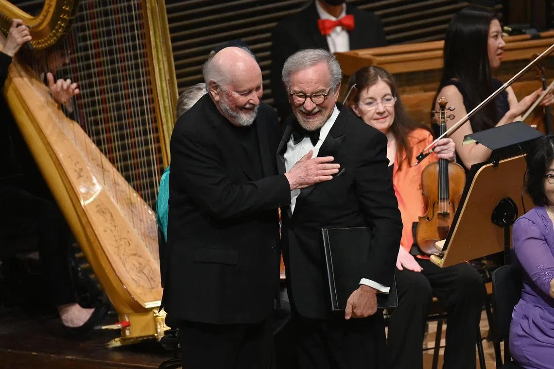 Director Steven Spielberg (R) introduces composer John Williams (L) during The New York Philharmonic Spring Gala: Celebrating John Williams at the Wu Tsai Theater, David Geffen Hall in New York City on April 25, 2023. - Spielberg and Williams have collaborated on 29 feature films. (Photo by ANGELA WEISS / AFP)