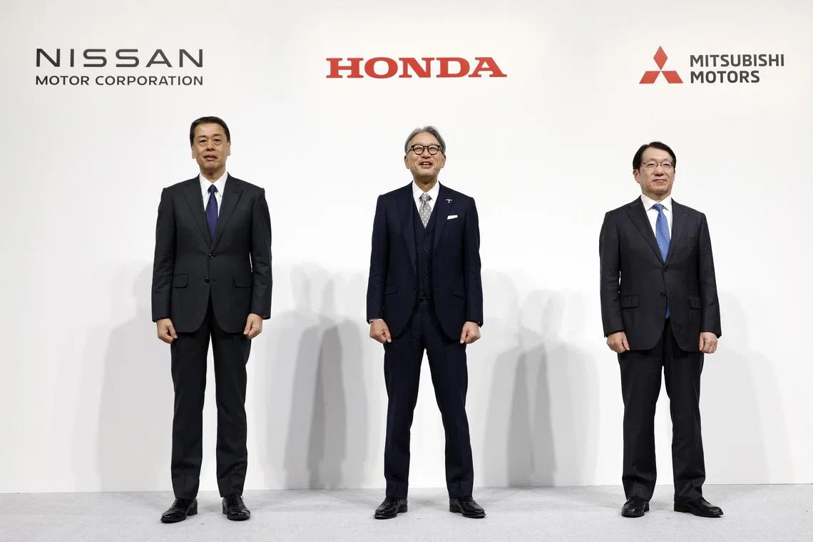epa11790867 (L-R) Nissan Motor Co. President and CEO Makoto Uchida, Honda Motor Co. President Toshihiro Mibe, and Mitsubishi Motors Corp. President and CEO Takao Kato pose at the end of a joint press conference in Tokyo, Japan, 23 December 2024. Nissan, Honda, and Mitsubishi Motors have signed a memorandum of understanding (MOU) to explore Mitsubishi Motors’ potential participation and synergy-sharing in the business integration outlined in a previous MOU between Nissan and Honda, which includes the establishment of a joint holding company.  EPA-EFE/FRANCK ROBICHON