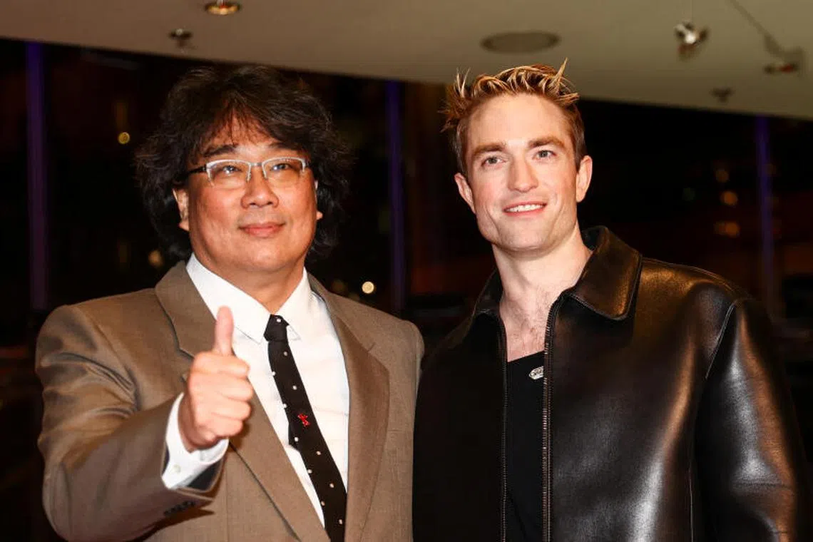 Director Joon-ho Bong and Robert Pattinson attend the screening of Mickey 17 at the 75th Berlinale International Film Festival.