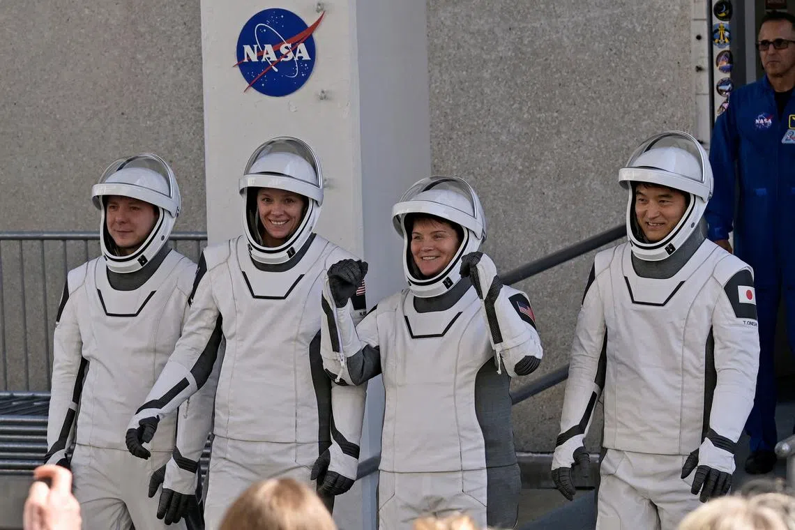 NASA's  SpaceX Crew-10 Cosmonaut  Mission Specialist Kirill Peskov of Roscosmos of Russia,  Pilot Nichole Ayers and Commander Anne McClain of U.S. and Mission Specialist Takuya Onishi of Japan's JAXA,  walk from the Operations & Checkout Building at the Kennedy Space Center for transport to Launch Complex 39-A ahead of their launch to the International Space Station in Cape Canaveral, Florida, U.S., March 12, 2025. REUTERS/Steve Nesius