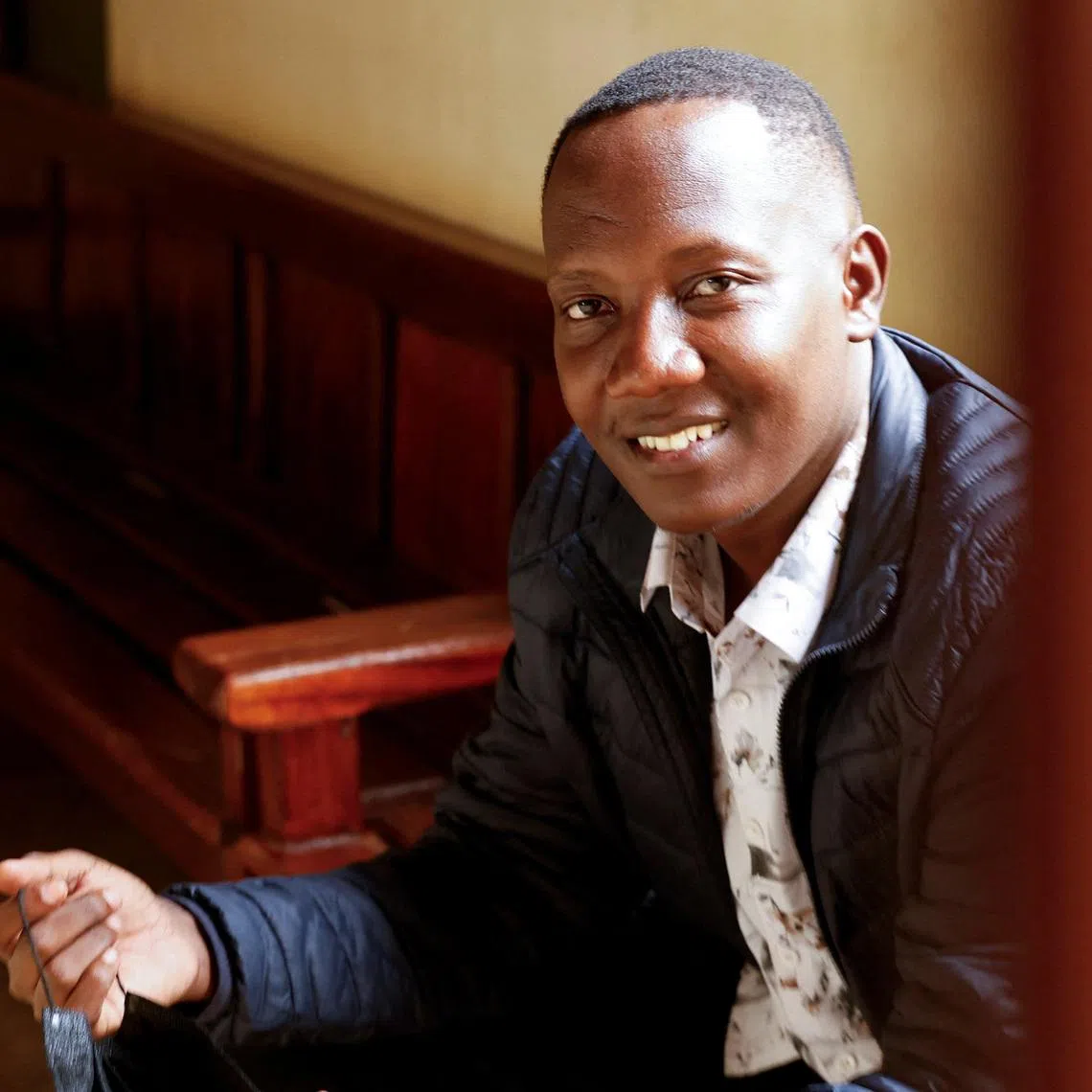 Festus Omwamba sits when he appeared at the Kahawa Law Courts to hear charges of recruiting Kenyans into the Russian armed forces, at the Kahawa Law Courts in Kiambu, Kenya, February 26, 2026. REUTERS/Monicah Mwangi