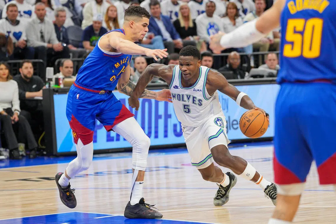 Minnesota Timberwolves guard Anthony Edwards dribbles against Denver Nuggets forward Michael Porter Jr. in the third quarter of Game 6 of the NBA Western Conference semi-finals.