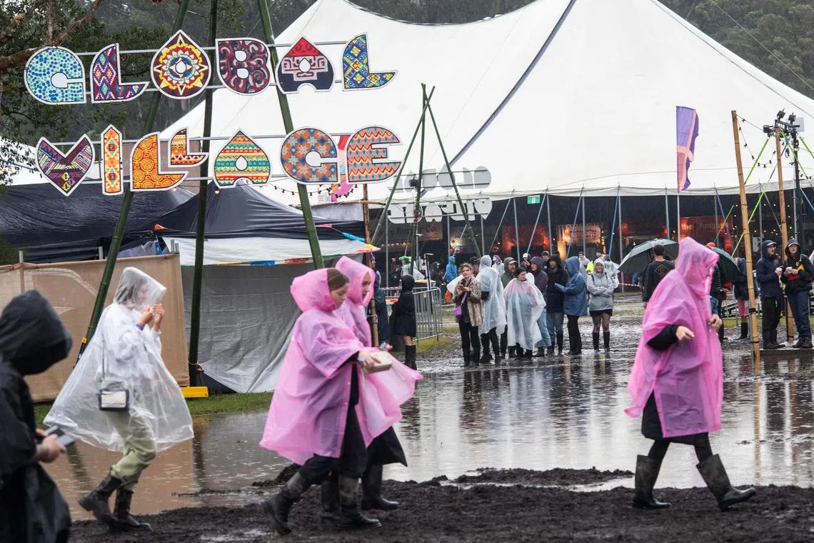 BYRON BAY, AUSTRALIA - JULY 22: Festivalgoers are seen in the rain and the mud at Splendour in the Grass 2022 on July 22, 2022 in Byron Bay, Australia.  (Photo by Marc Grimwade/WireImage)