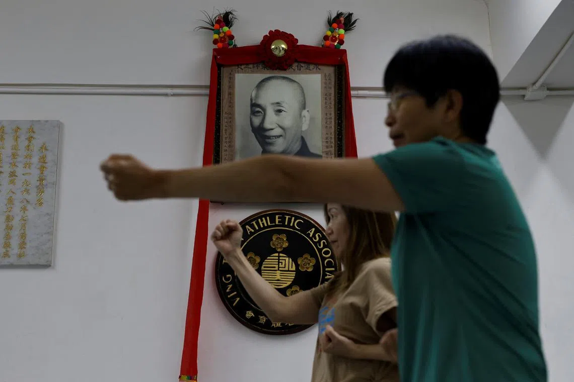 Practitioners training in front of a photo of grandmaster Ip Man during a Wing Chun class on July 14.