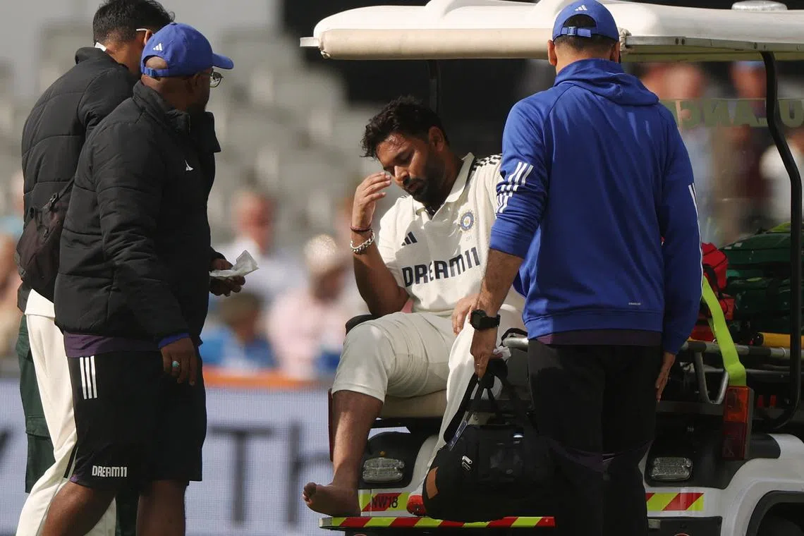 Cricket - International Test Match Series - Fourth Test - England v India - Old Trafford Cricket Ground, Manchester, Britain - July 23, 2025 India's Rishabh Pant reacts as he is stretchered off after being hit on the foot by a ball bowled by England's Chris Woakes Action Images via Reuters/Lee Smith