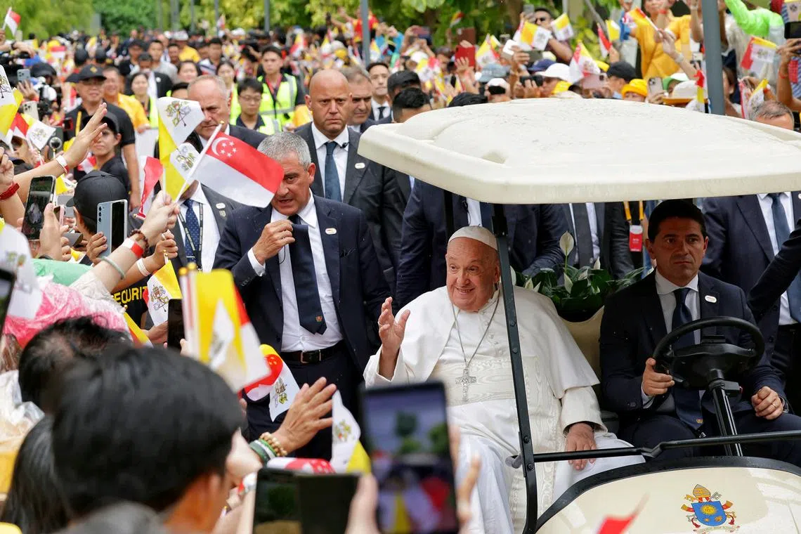 Pope Francis, the head of the worldwide Catholic Church, being greeted by members of the Catholic community at Jurassic Mile after landing in Singapore on Sept 11, 2024. 