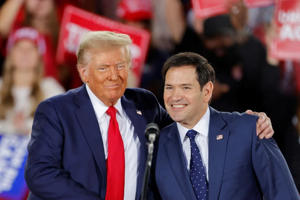 Republican presidential nominee and former U.S. President Donald Trump and and  Senator Marco Rubio (R-FL) react during a campaign event at Dorton Arena, in Raleigh, North Carolina, U.S. November 4, 2024.   REUTERS/Jonathan Drake/File Photo