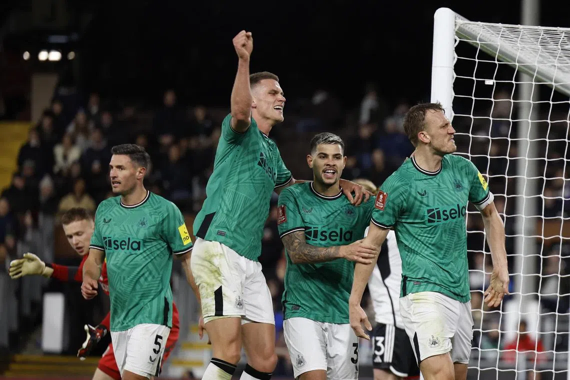 Newcastle United's Dan Burn celebrates scoring their second goal with Bruno Guimaraes and Sven Botman.