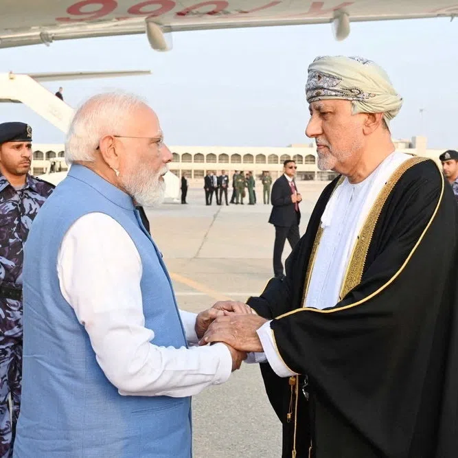 Oman's Deputy Prime Minister for Defence Affairs Sayyid Shihab bin Tariq Al Said welcomes Indian Prime Minister Narendra Modi upon his arrival in Muscat, Oman, December 17, 2025. Oman News Agency/Handout via REUTERS