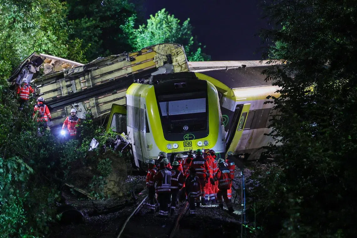 Emergency workers at the accident site of a derailed passenger train near Riedlingen, Germany, on July 28, 2025. 