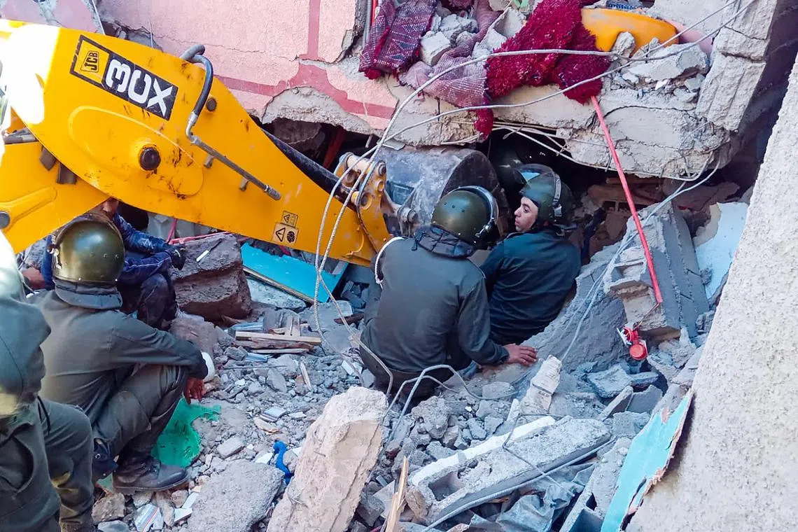 Rescue workers search for survivors at a collapsed house, after a devastating earthquake struck the mountains south-west of Morocco's Marrakesh.