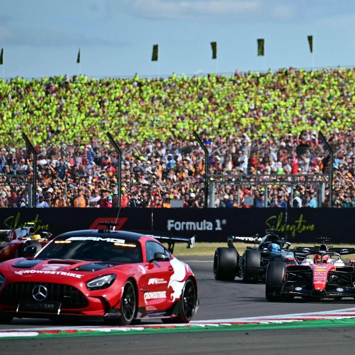 Ferrari’s driver Charles Leclerc (right) and Mercedes’ driver George Russell (second from right) behind the safety car during the Formula One British Grand Prix on July 5.