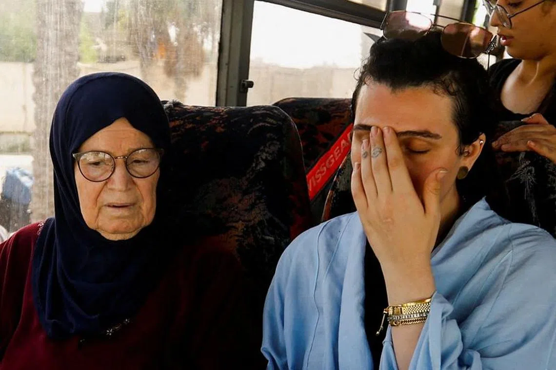 FILE PHOTO: Suzan Beseiso, a Palestinian holding a U.S. passport, reacts while sitting next to her grandmother in a vehicle, as she waits for permission to leave Gaza, amid the ongoing conflict between Israel and Palestinian Islamist group Hamas, at the Rafah border crossing with Egypt, in Rafah in the southern Gaza Strip, November 2, 2023. REUTERS/Ibraheem Abu Mustafa/File Photo