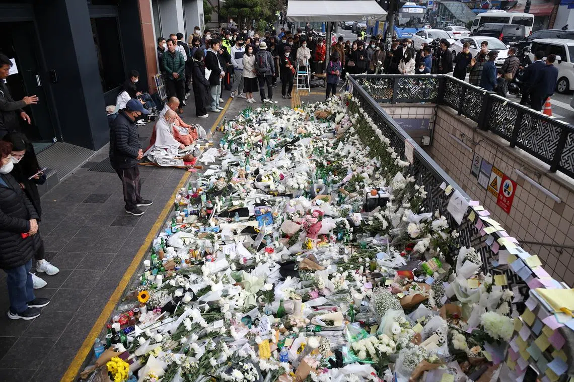 Mourners attend a floral tribute near the scene of a crowd crush that happened during Halloween festivities, in Seoul, South Korea, Nov 1, 2022. 