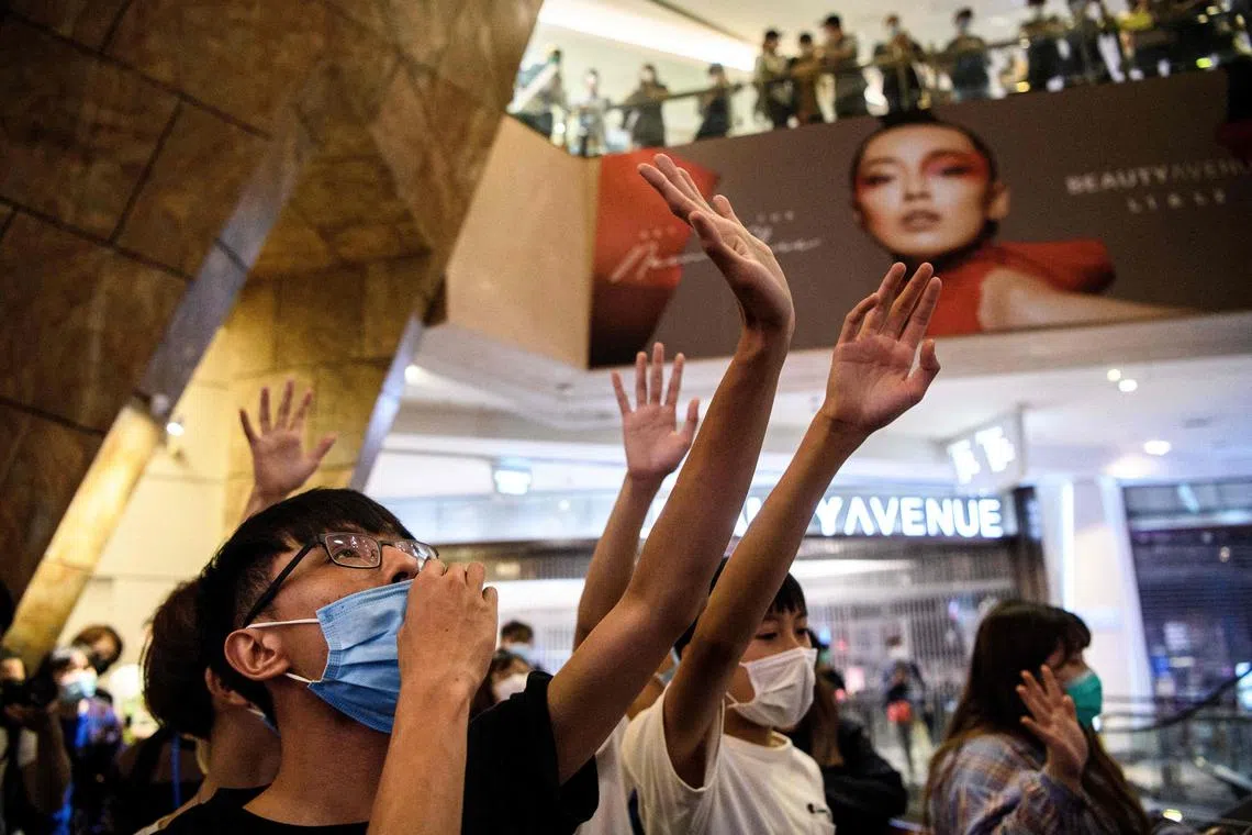 This photo taken on May 13, 2020, shows anti-government protesters singing the protest anthem Glory To Hong Kong as they gather in a shopping mall in Hong Kong.