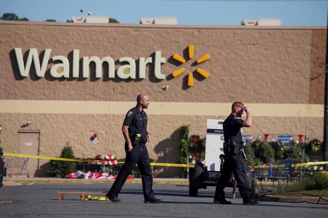 Police walk through the parking lot after a mass shooting at a Walmart in Chesapeake, Virginia, U.S on Nov 23, 2022. 