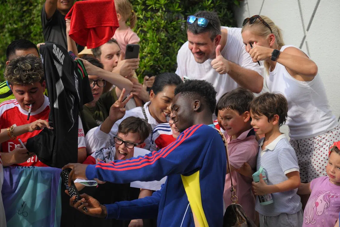 Bukayo Saka of Arsenal Football Club signing autographs and taking pictures with fans waiting at W Singapore Sentosa Cove, on July 20, 2025.