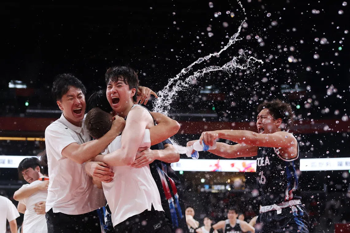 South Korea team members celebrate after winning gold at the Asian Games.