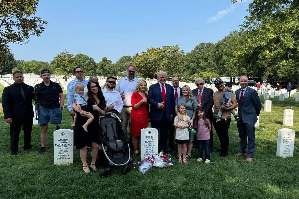Trump was pictured giving a thumbs-up at the grave of one of 13 US Marines killed in a Taliban bombing in Afghanistan in 2021, with members of the Marine's family.