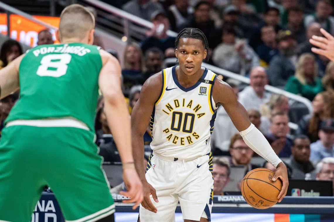 Indiana Pacers guard Bennedict Mathurin dribbles the ball while Boston Celtics centre Kristaps Porzingis defends in the second half at Gainbridge Fieldhouse. 