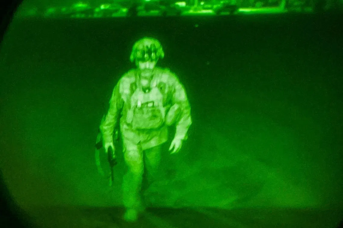 FILE PHOTO: U.S. Army Major General Chris Donahue, commander of the 82nd Airborne Division, steps on board a C-17 transport plane as the last U.S. service member to leave Hamid Karzai International Airport in Kabul, Afghanistan August 30, 2021 in a photograph taken using night vision optics.  XVIII Airborne Corps/Handout via REUTERS