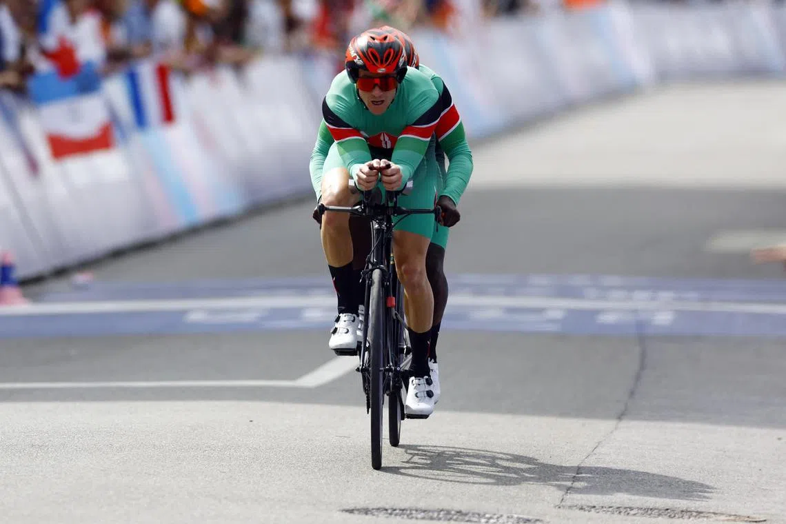 Kennedy Ogada of Kenya and pilot Oscar Dennis competing at the Paris Paralympics.