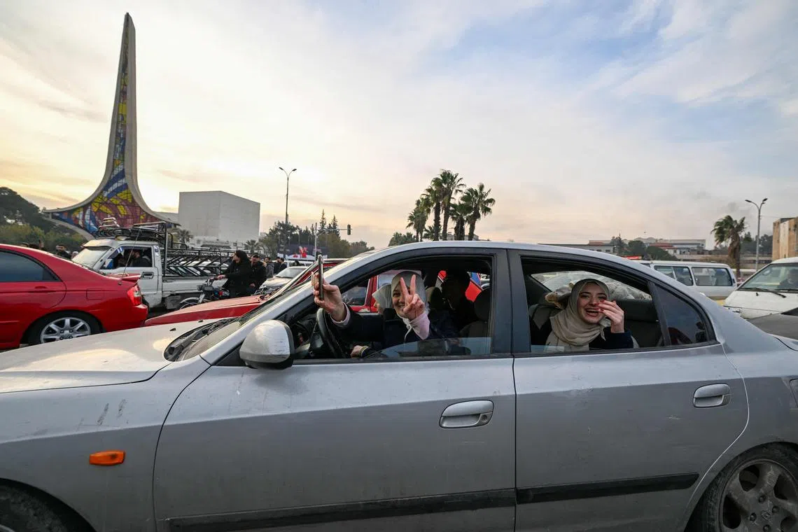 People celebrating at Umayyad Square in Damascus on Dec 8, 2024 after the fall of the Assad regime.  