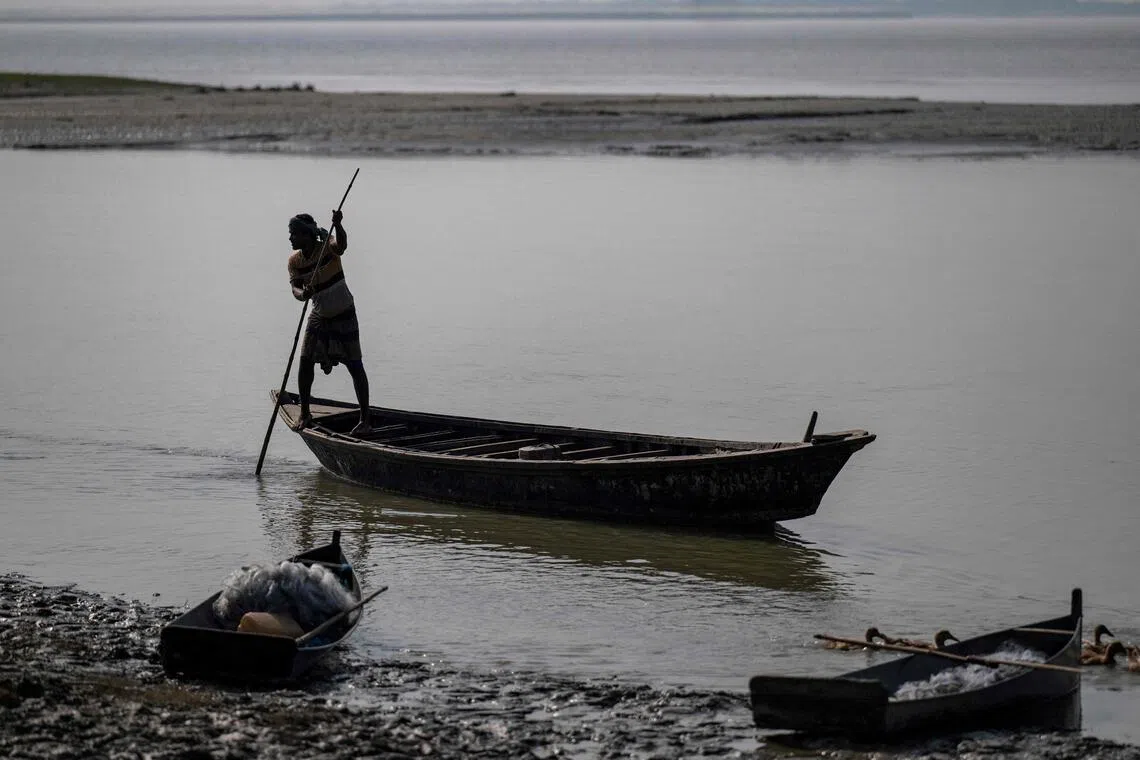 A man ferrying a boat along the Padma river at Ramnathpur village, near the Bangladesh-India frontier in Bangladesh’s Rajshahi division, on Oct 13.